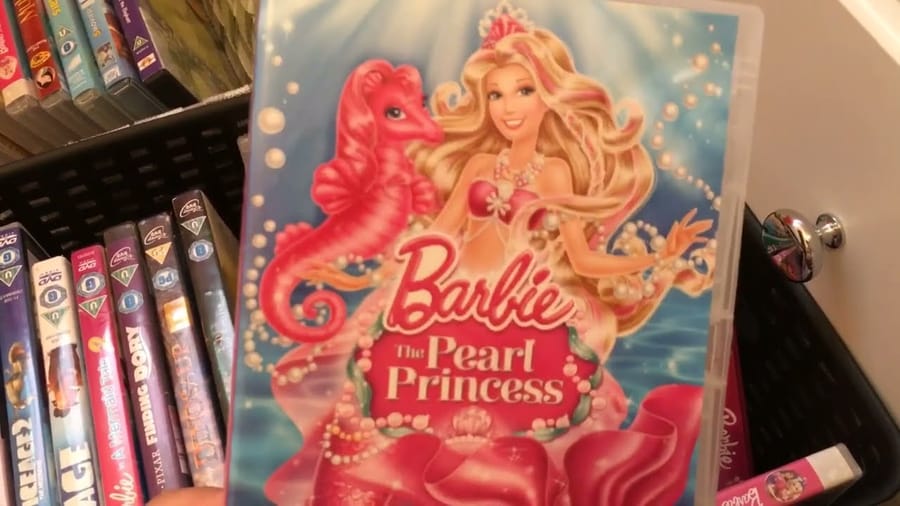 Collection of Barbie movie DVDs showcasing various Barbie adventures