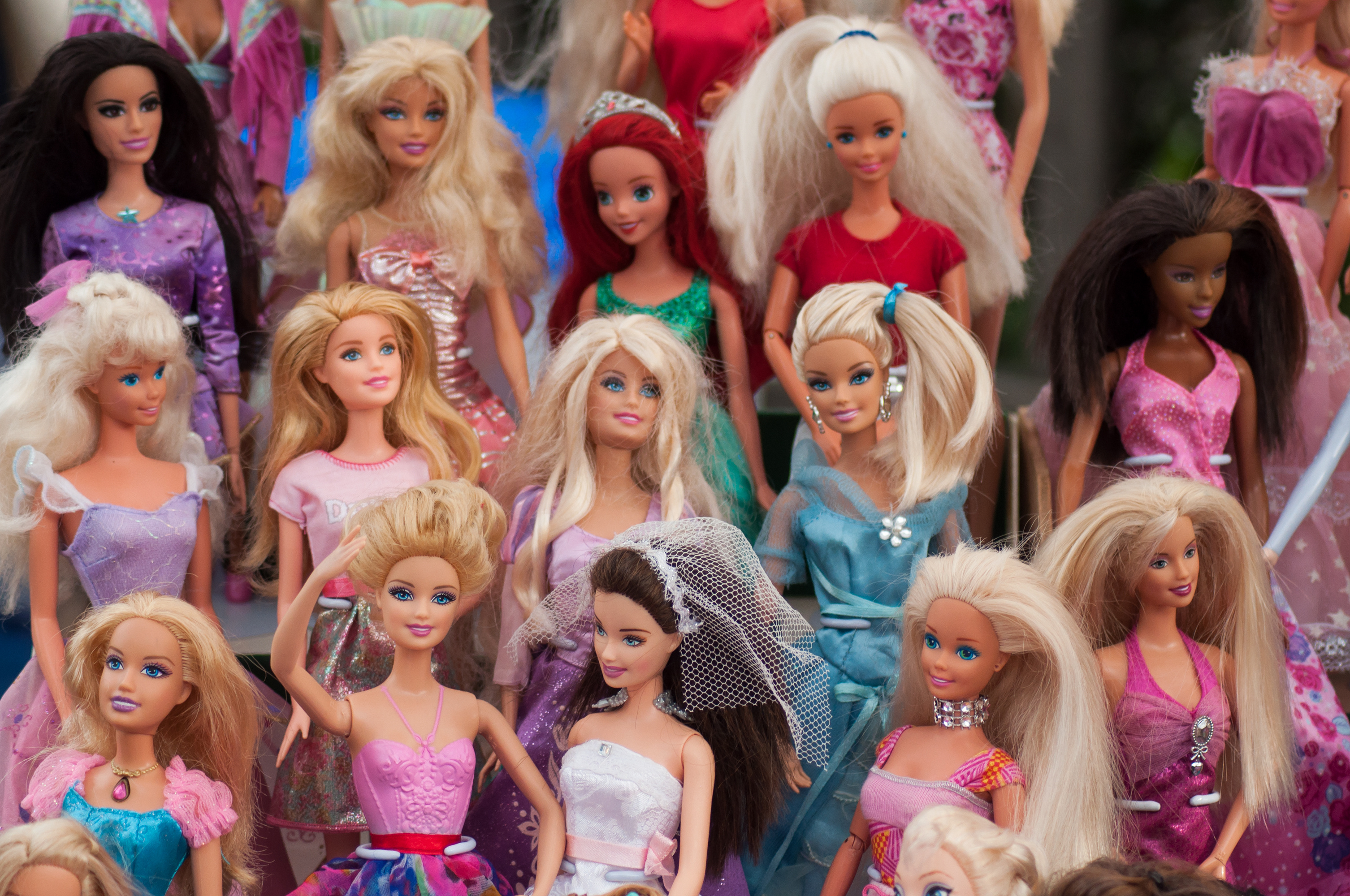Collage of various Barbie dolls and their accessories